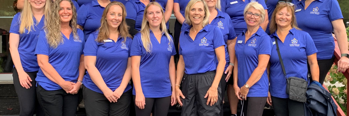 Photo of group of women wearing blue polo shirts