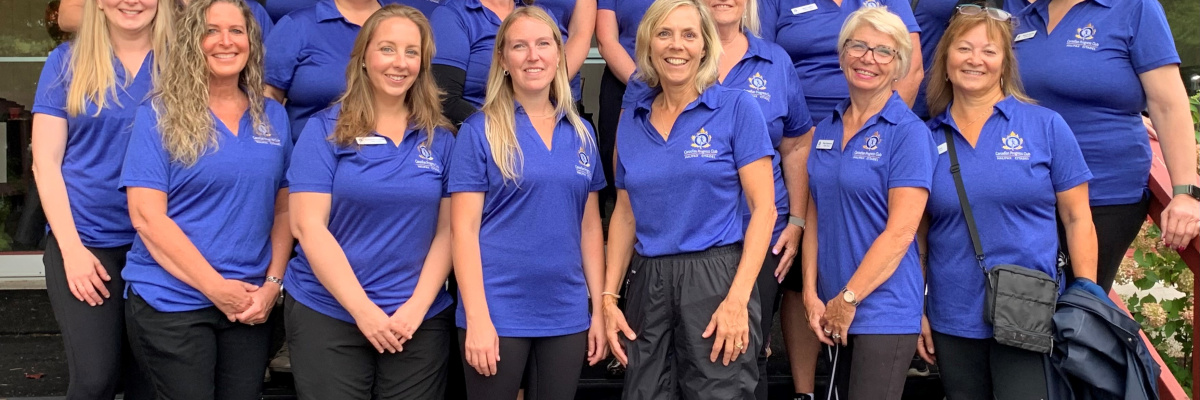 Photo of group of women wearing blue polo shirts